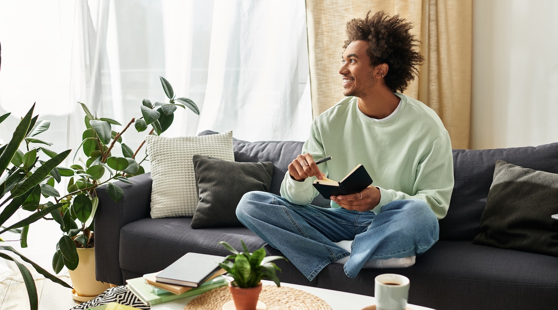 a person sitting on a couch holding a notebook