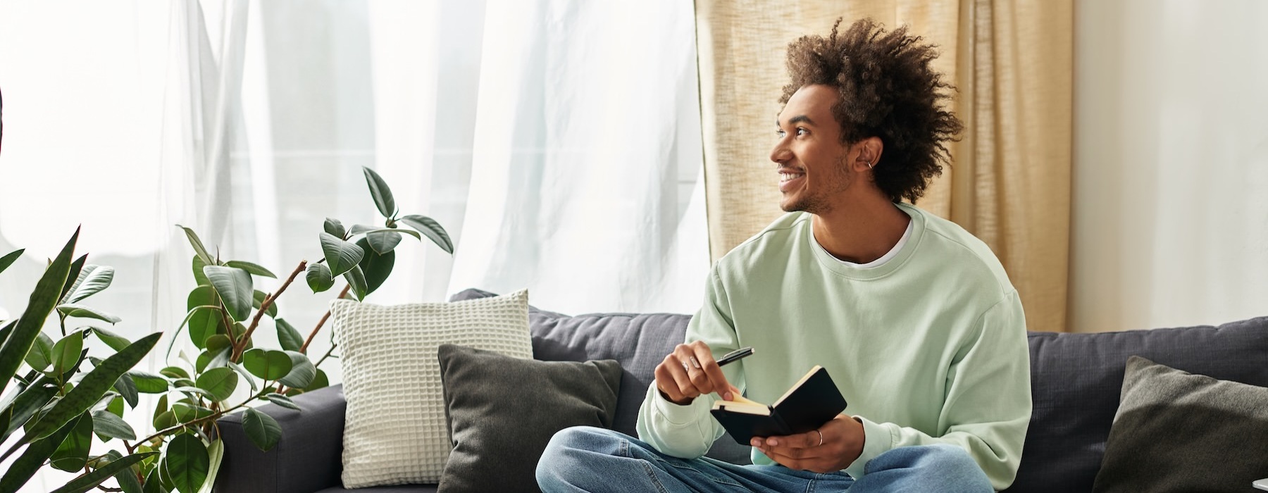 a person sitting on a couch holding a notebook