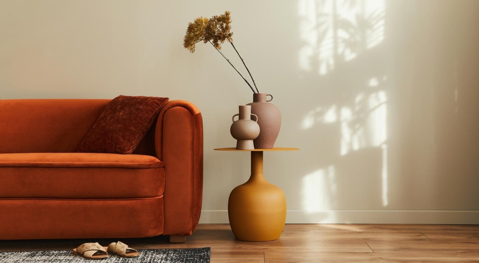 a living room with a couch, table and a vase