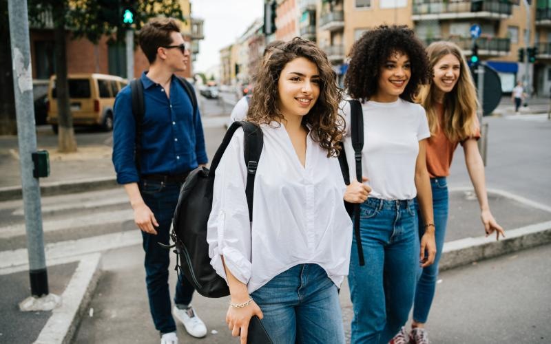 a group of people walking on a sidewalk